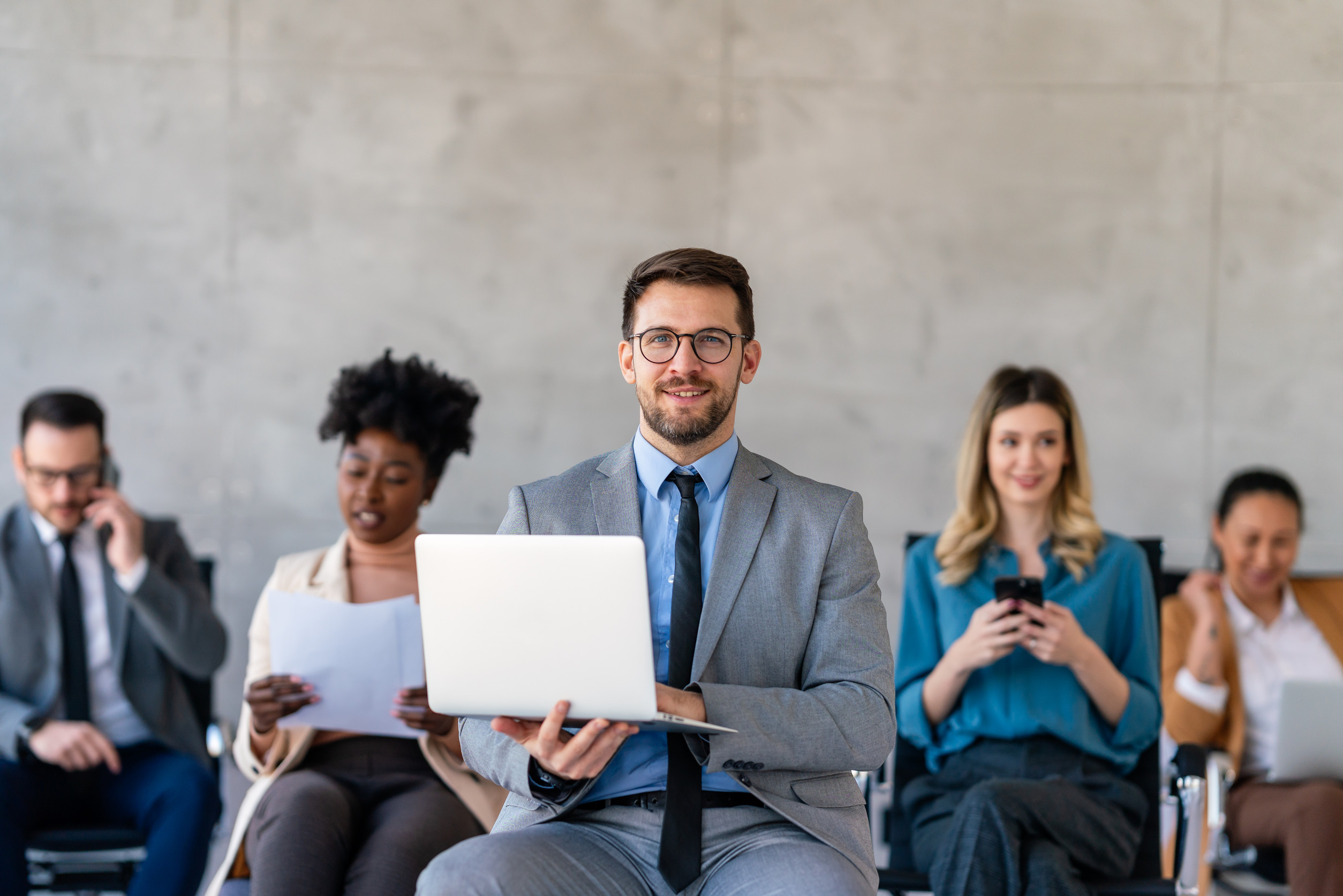 Multicultural professional businesspeople working together on research plan in boardroom.